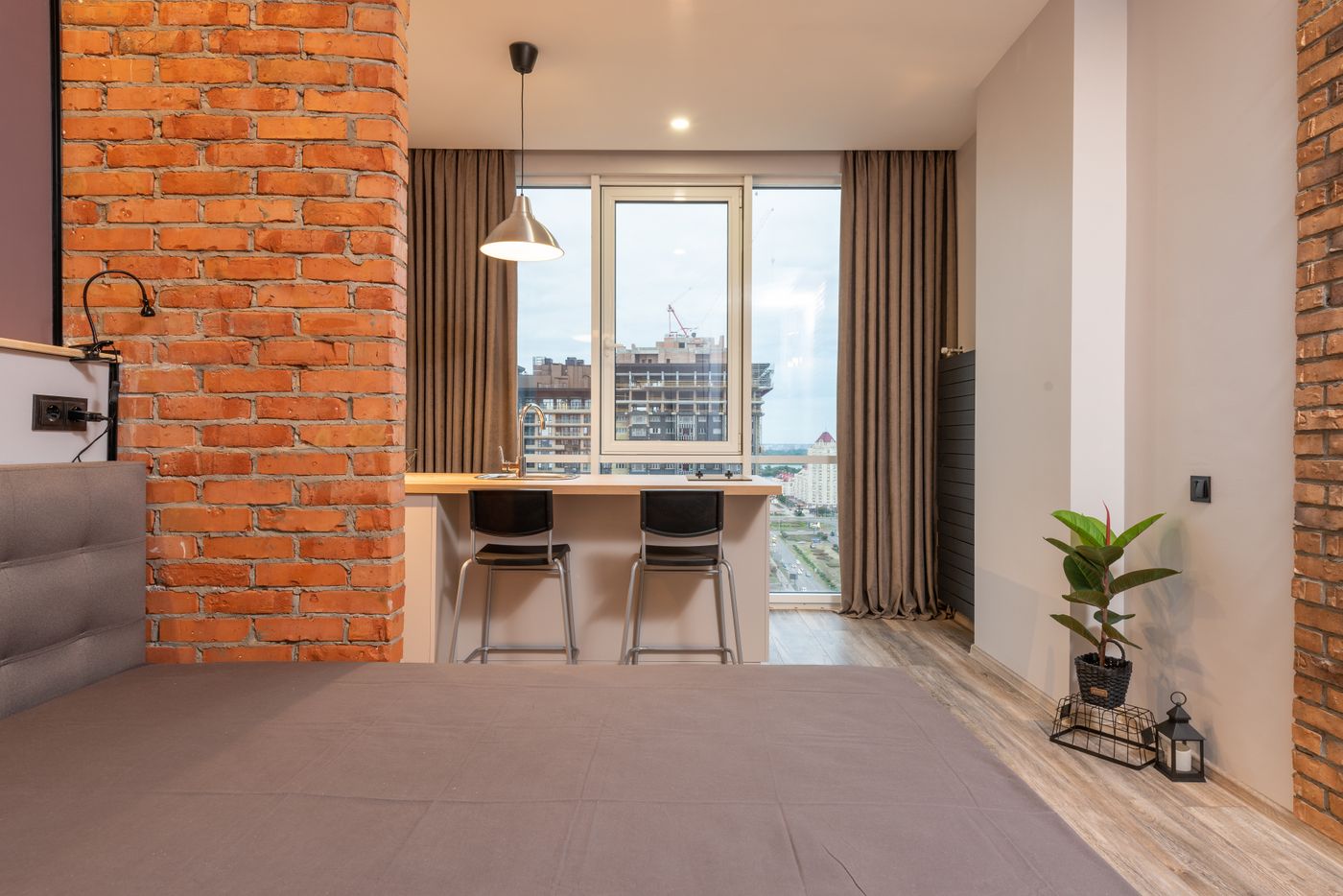 Sleeping area beside a brick divider and a bright window counter